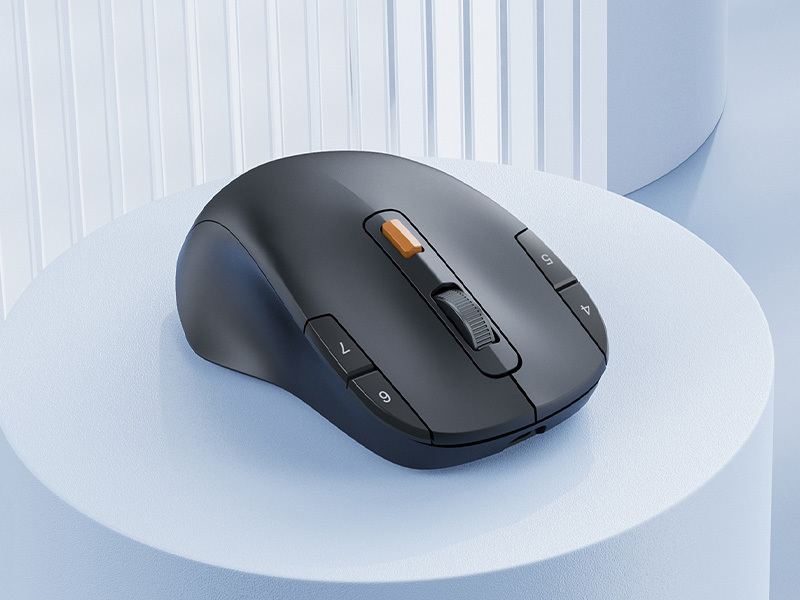 Close-up of a dark grey ergonomic wireless mouse featuring side buttons for thumb control.