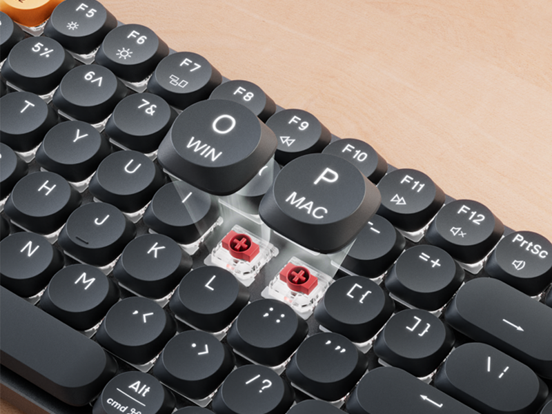 Mechanical keyboard with 'WIN' and 'MAC' keys removed, showing red switches
