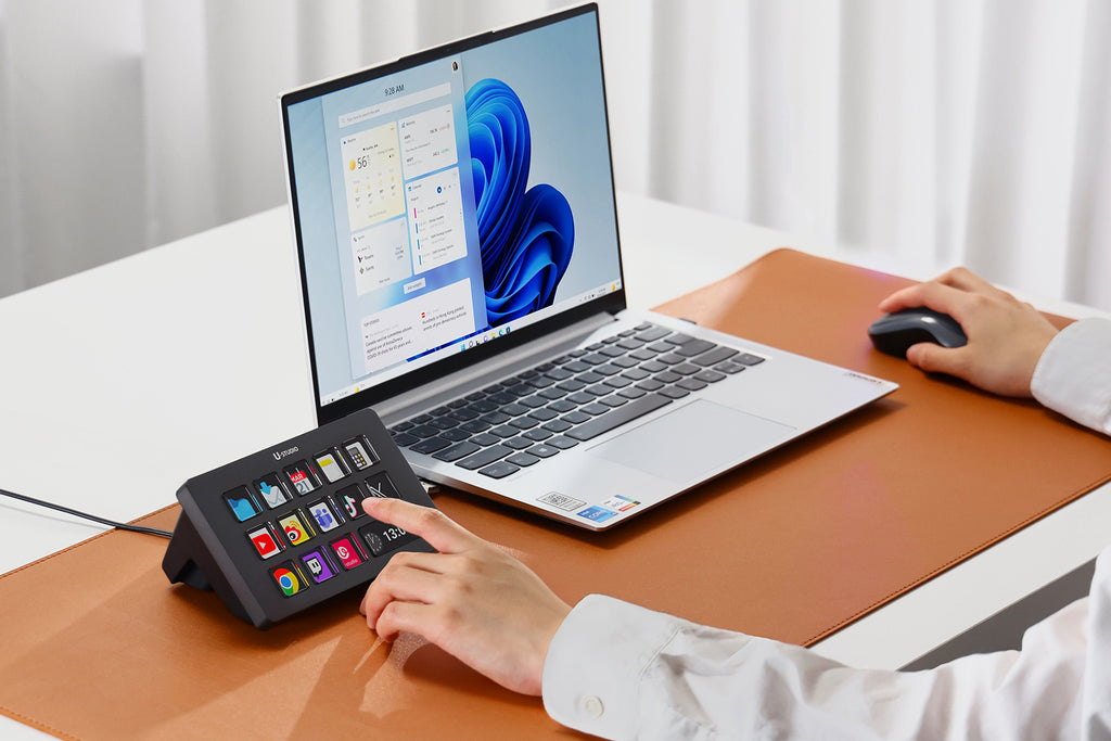 Person using U-Studio console with laptop on tan desk mat