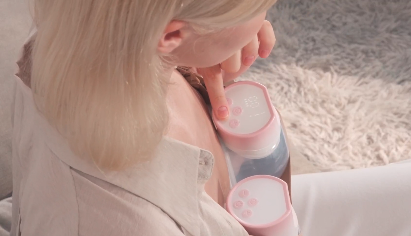 Woman using wearable breast pump