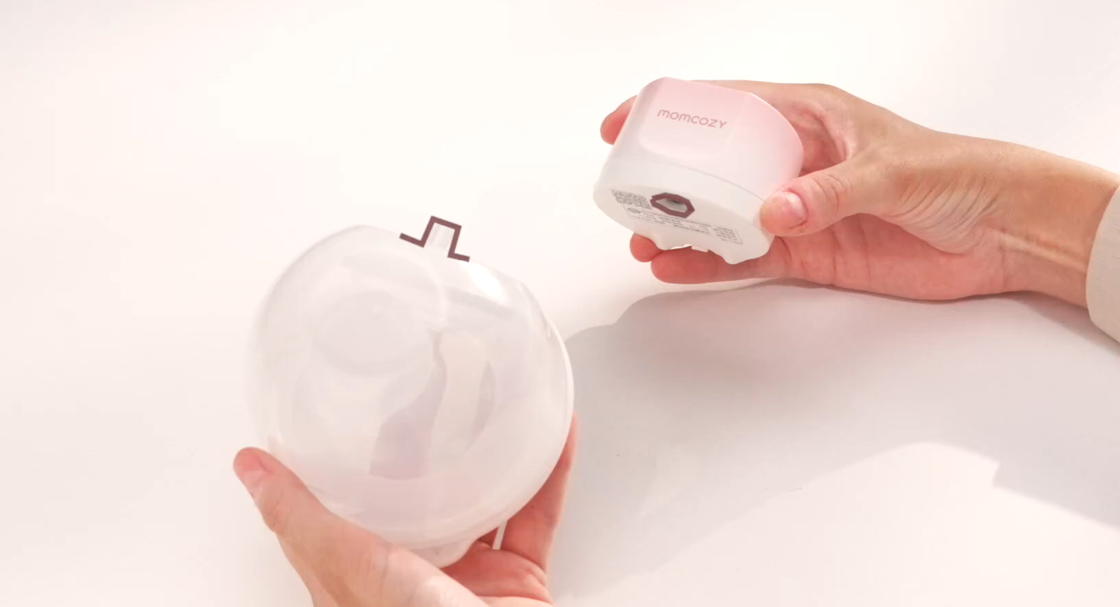 Momcozy portable breast pump parts being assembled