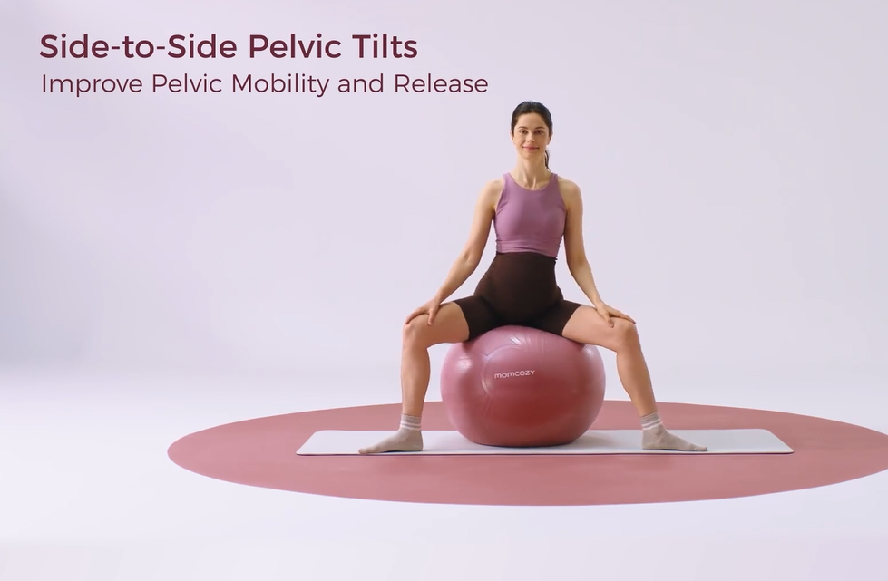 Pregnant woman sits on exercise ball, performing side-to-side pelvic tilts for mobility
