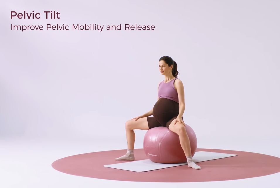 Pregnant woman performing pelvic tilt on stability ball for mobility