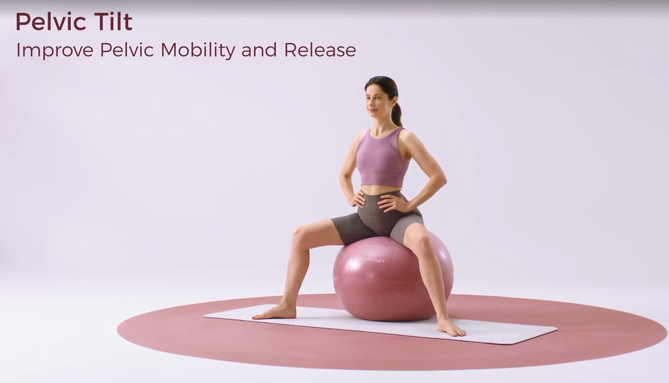 Woman performing pelvic tilt exercise while seated on a large pink ball for mobility