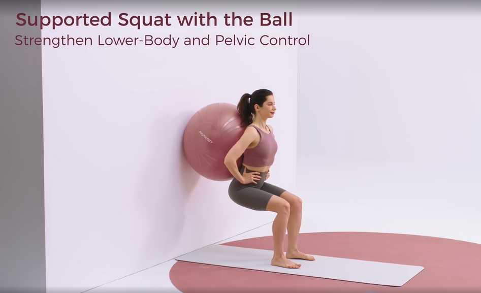 Woman doing a wall-supported squat with an exercise ball for lower-body and pelvic control