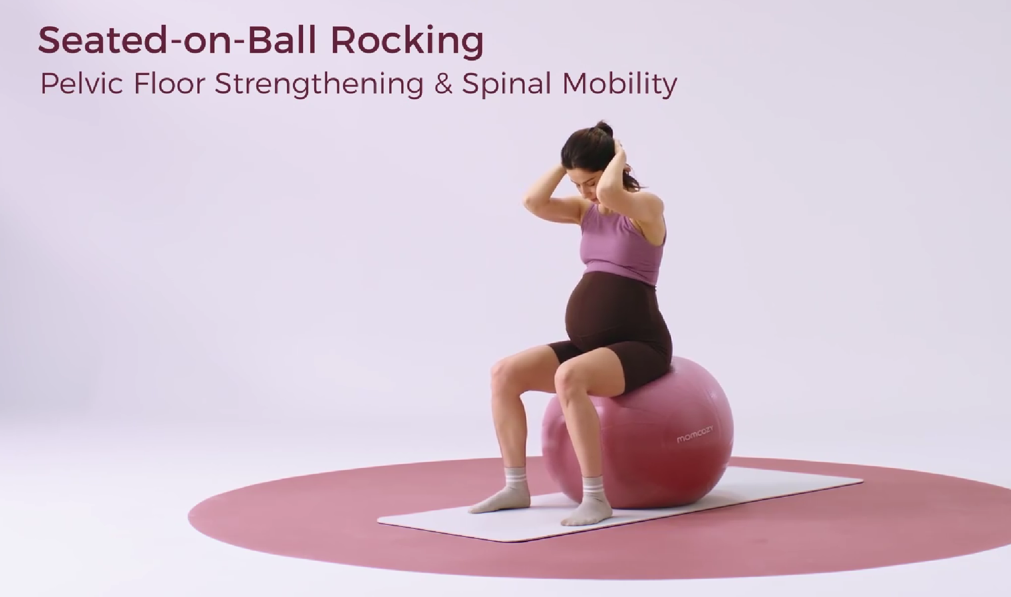 Pregnant woman seated-on-ball rocking for pelvic floor strengthening and spinal mobility
