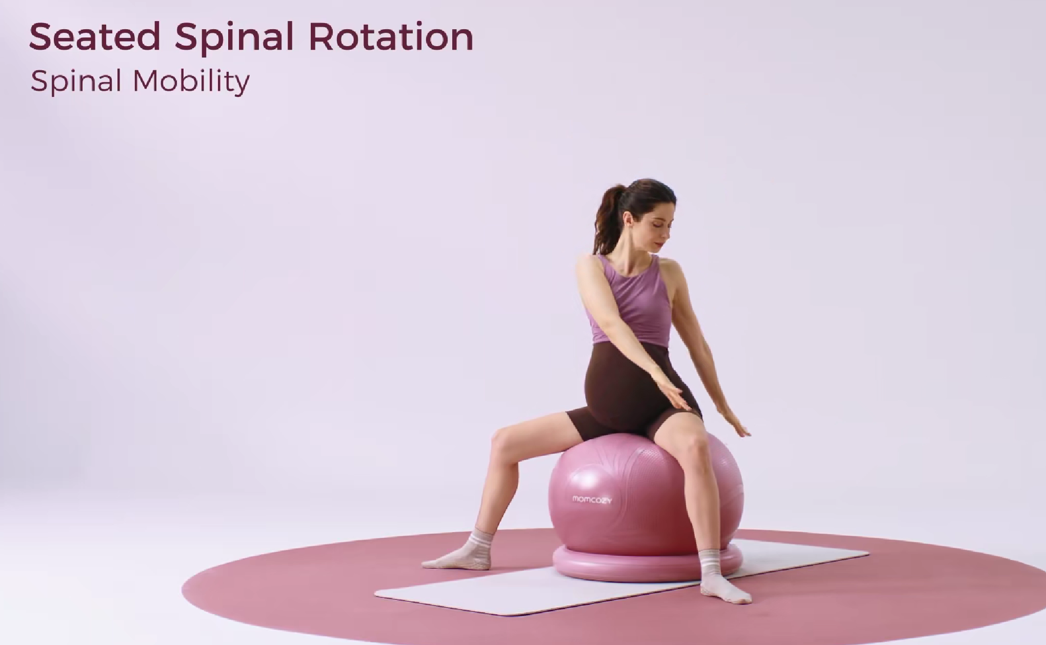 Woman performing Seated Spinal Rotation on yoga ball for spinal mobility